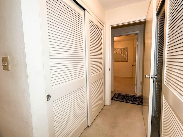 hallway with light colored carpet