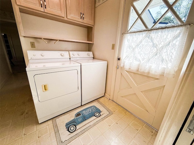 laundry area featuring cabinet space, light floors, and washer and clothes dryer