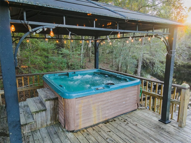 wooden terrace featuring an outdoor hot tub