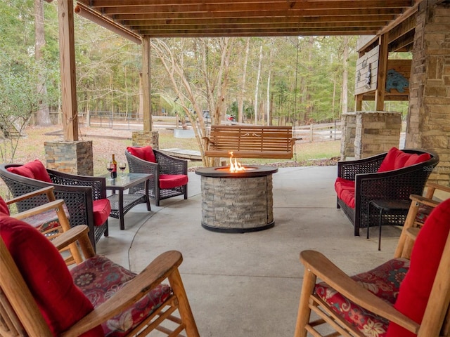 view of patio featuring an outdoor living space with a fire pit