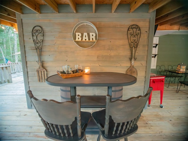 dining room featuring wood-type flooring and wood walls