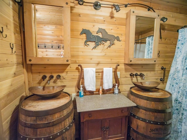 bathroom with sink and wooden walls