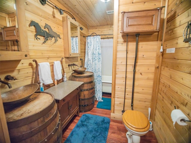 full bathroom with shower / bath combo, sink, wooden ceiling, hardwood / wood-style floors, and wooden walls