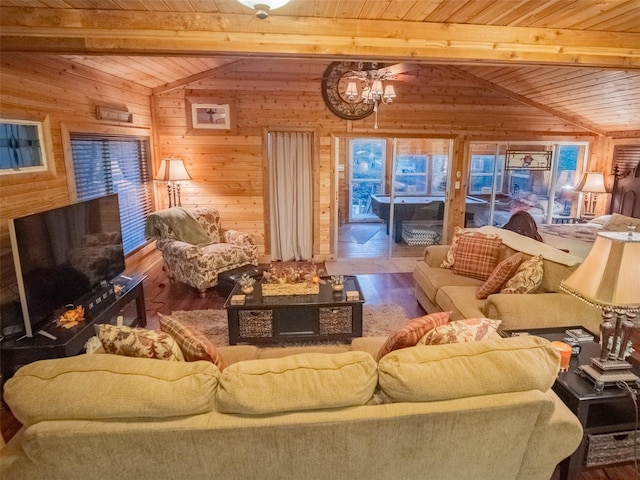 living room with wood walls, wooden ceiling, hardwood / wood-style floors, and lofted ceiling with beams