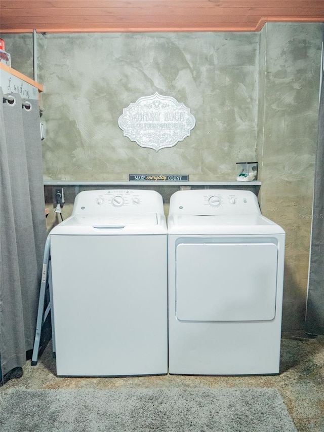 laundry area with washing machine and dryer and wood ceiling