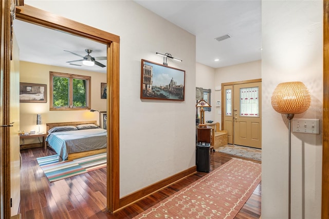 hallway with dark hardwood / wood-style flooring