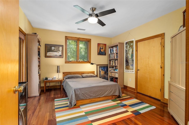 bedroom featuring ceiling fan and dark wood-type flooring