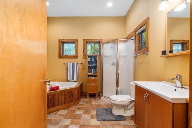 full bathroom featuring toilet, vanity, and separate shower and tub