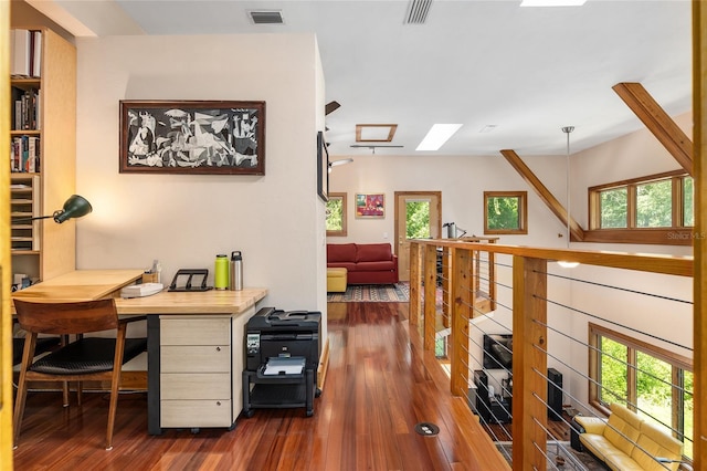 office area featuring dark hardwood / wood-style floors and a skylight