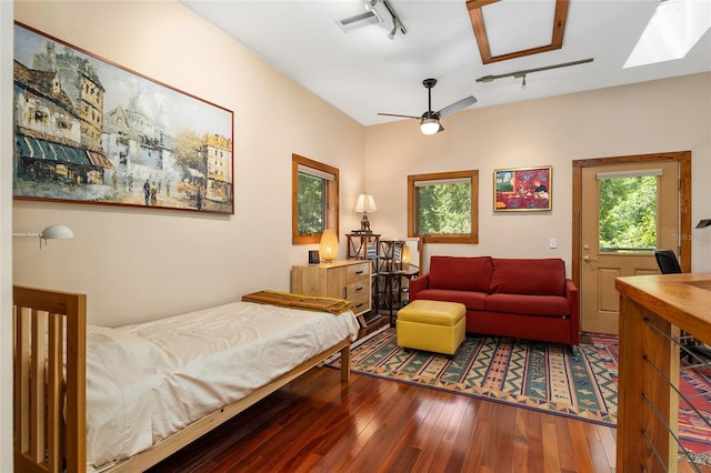 bedroom with track lighting, ceiling fan, and wood-type flooring