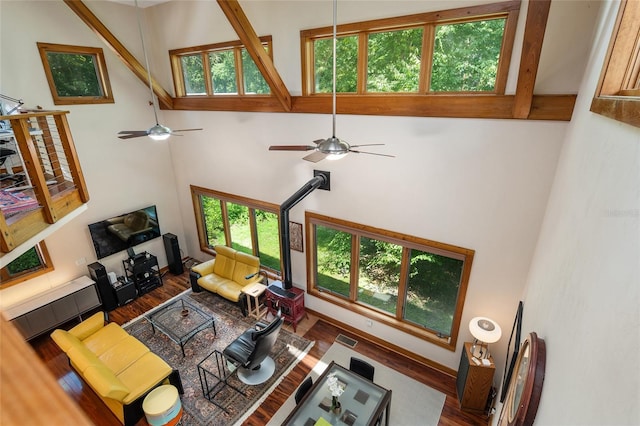 living room with wood-type flooring and a high ceiling