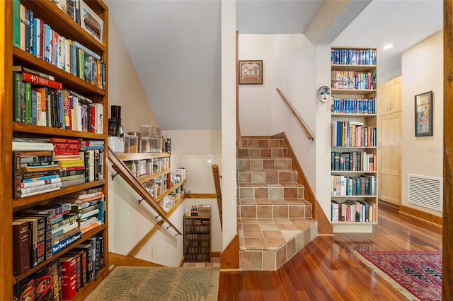 stairway with hardwood / wood-style flooring