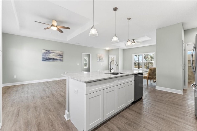 kitchen with sink, decorative light fixtures, dishwasher, a kitchen island with sink, and white cabinets