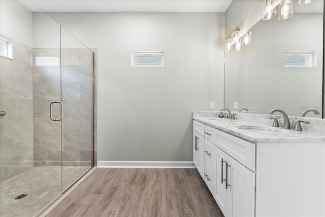 bathroom with vanity, hardwood / wood-style floors, and walk in shower