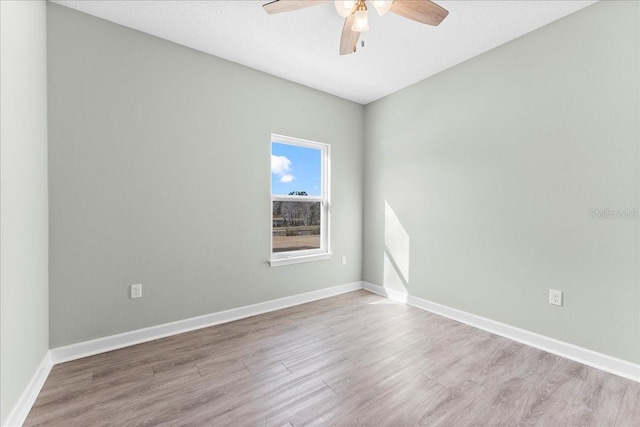 empty room featuring ceiling fan and light wood-type flooring