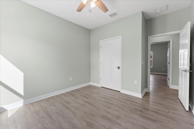 unfurnished bedroom featuring ceiling fan and light hardwood / wood-style floors