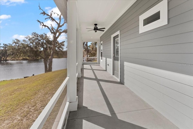 view of patio / terrace featuring ceiling fan and a water view