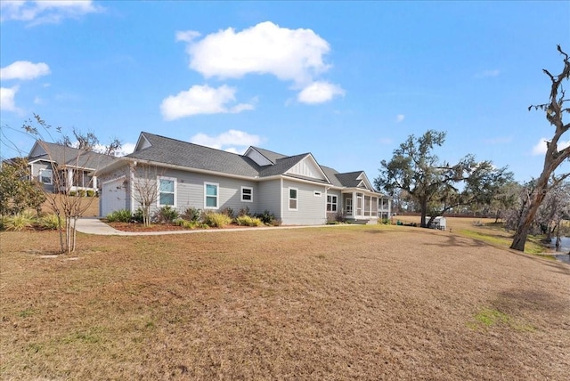 view of front of house with a garage and a front lawn