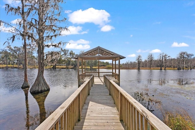 view of dock with a gazebo and a water view