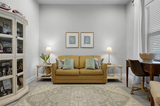 living area featuring wood finished floors and baseboards