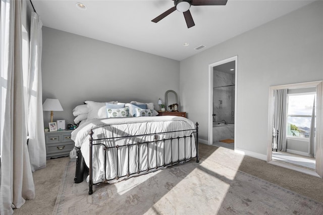 bedroom with visible vents, baseboards, ceiling fan, carpet flooring, and ensuite bathroom