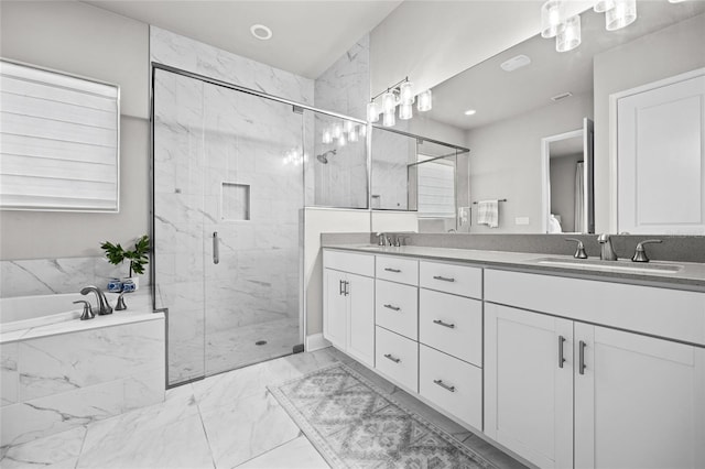 bathroom featuring double vanity, marble finish floor, a marble finish shower, and a sink