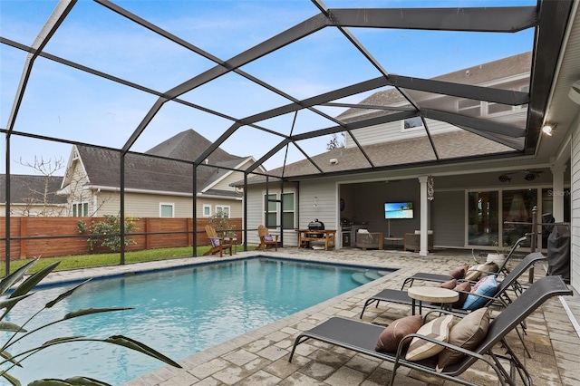 view of pool with a patio and a lanai