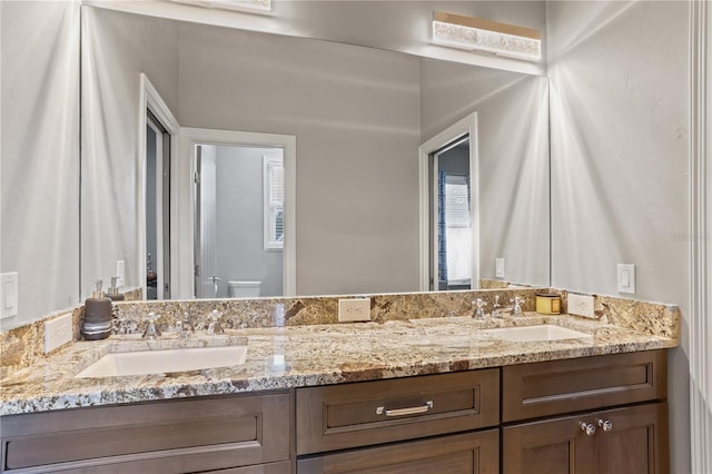 bathroom featuring vanity and toilet