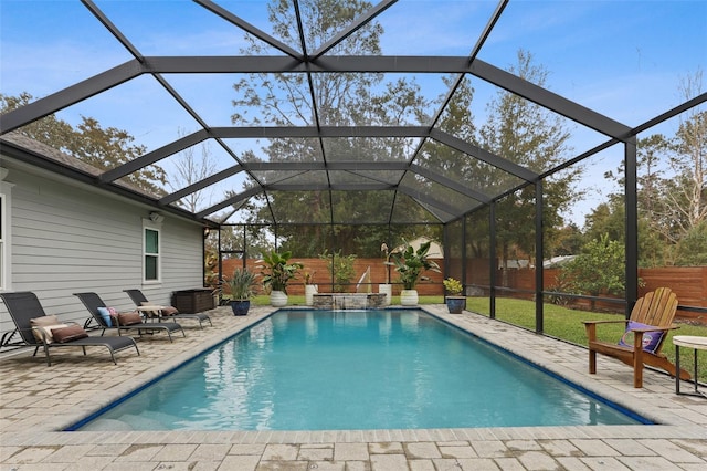 view of swimming pool featuring a patio and glass enclosure