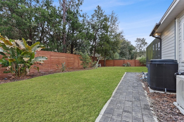 view of yard with cooling unit and a patio area