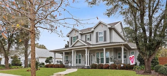 view of front of house with a porch and a front lawn