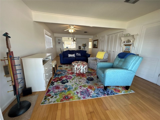 living room featuring ceiling fan and hardwood / wood-style floors