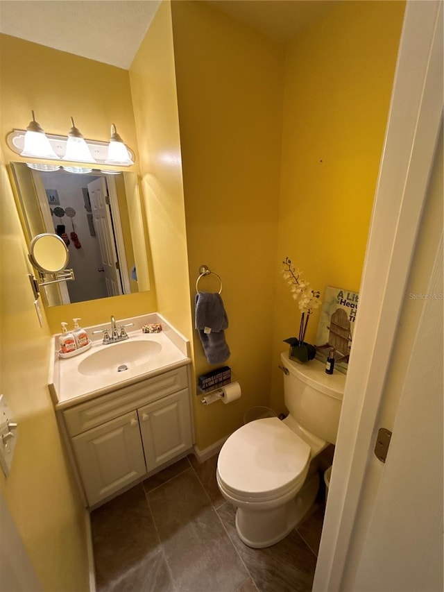 bathroom featuring vanity, toilet, and tile patterned flooring