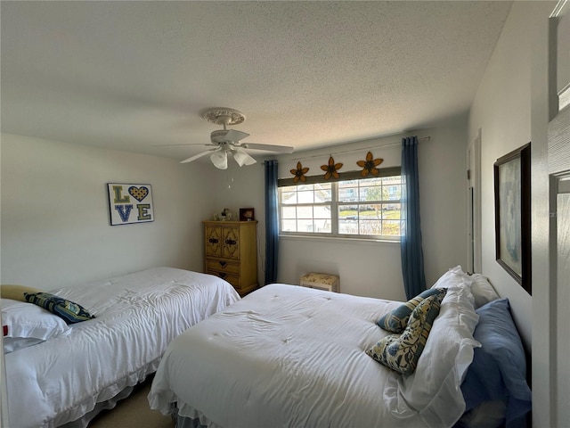 bedroom with a textured ceiling and ceiling fan