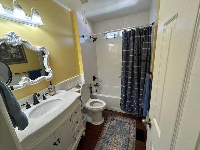 full bathroom featuring vanity, toilet, hardwood / wood-style floors, and shower / bath combo with shower curtain