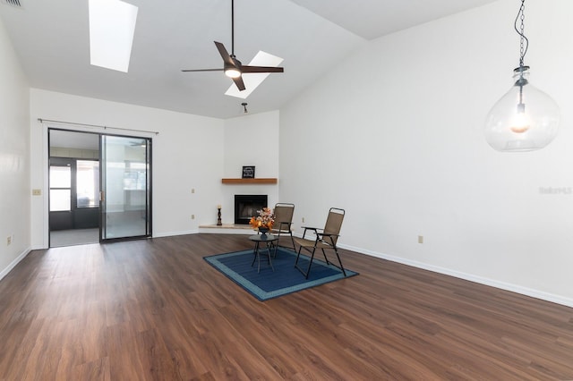 sitting room featuring a skylight, high vaulted ceiling, dark hardwood / wood-style floors, and ceiling fan