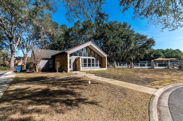 view of front of house featuring a front lawn and a sunroom