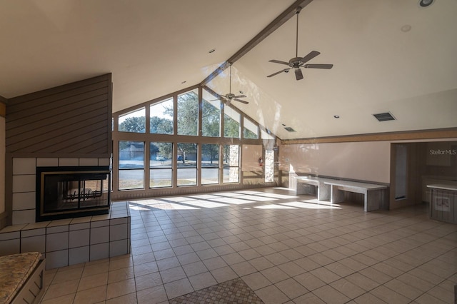 unfurnished living room featuring high vaulted ceiling, light tile patterned floors, a multi sided fireplace, a wall of windows, and beam ceiling