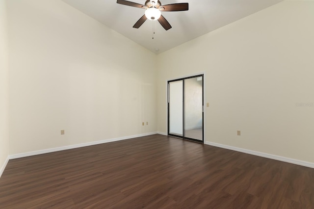 empty room with dark wood-type flooring, ceiling fan, and vaulted ceiling