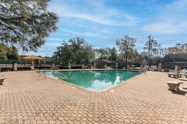 view of swimming pool with a gazebo and a patio area