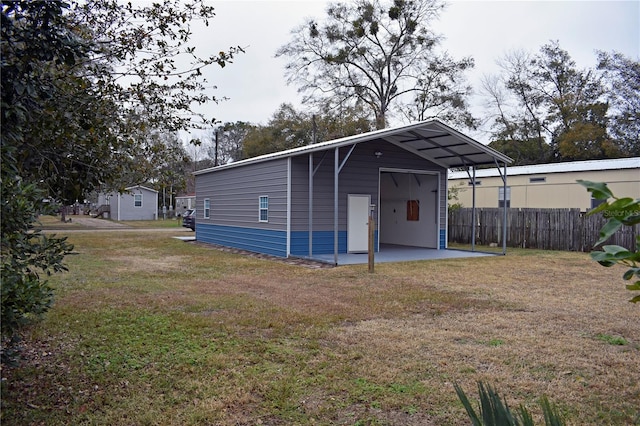 view of outdoor structure featuring a yard and a carport