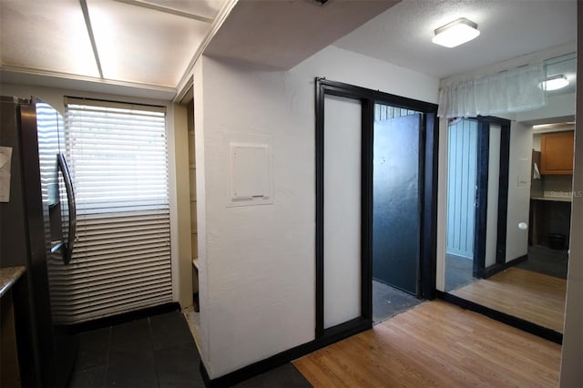 kitchen with stainless steel fridge with ice dispenser and hardwood / wood-style floors