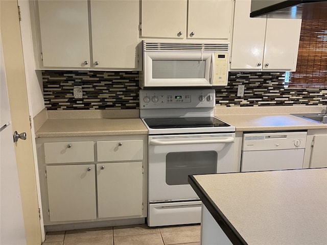 kitchen with light tile patterned floors, white appliances, decorative backsplash, and white cabinets