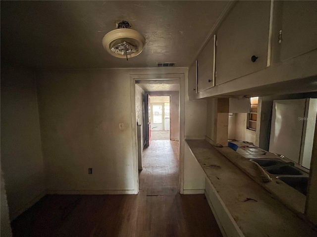 kitchen featuring hardwood / wood-style flooring and refrigerator