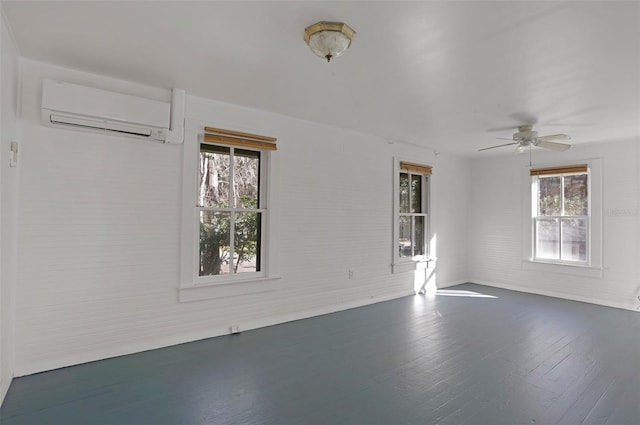 spare room featuring plenty of natural light, dark hardwood / wood-style floors, a wall mounted AC, and ceiling fan