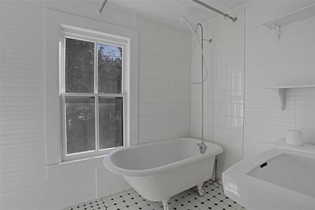 bathroom featuring tile patterned flooring and a tub