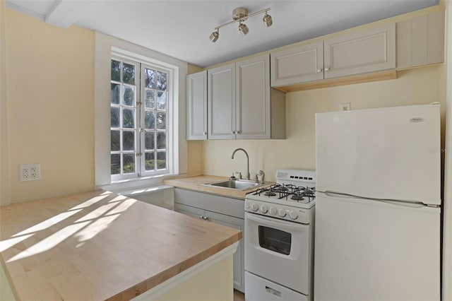 kitchen with sink and white appliances