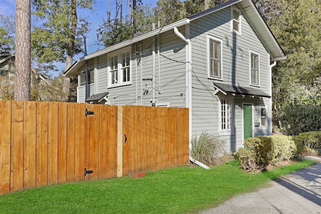 view of side of home featuring a lawn