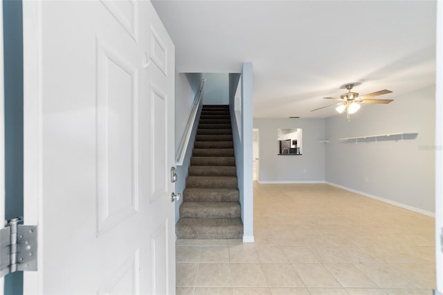 staircase with tile patterned flooring and ceiling fan