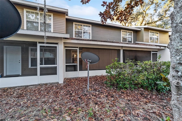 rear view of property with a sunroom